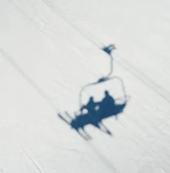 Shadow of a ski lift on the snow