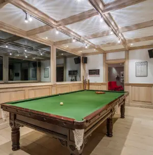 Billard under the ceiling with visible beams